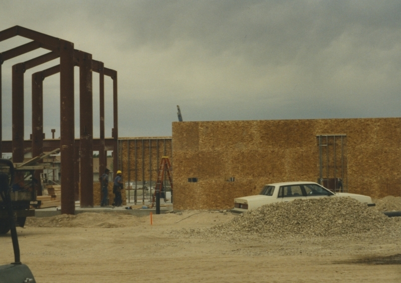 Photo shows work progressing on the Cherry Lane Library construction. Plywood walls and metal framing are visible in September 1996.