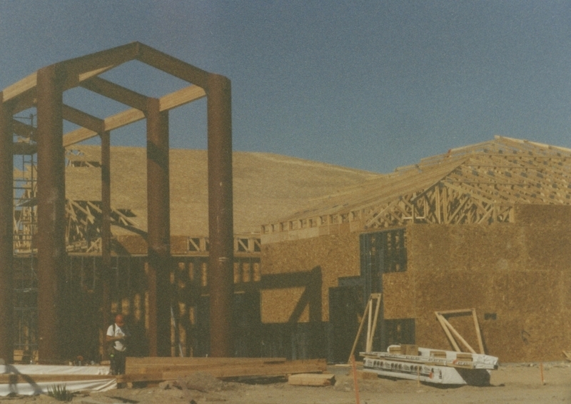 The facade of the Cherry Lane Library building under construction. Plywood walls and roof joists are visible. 