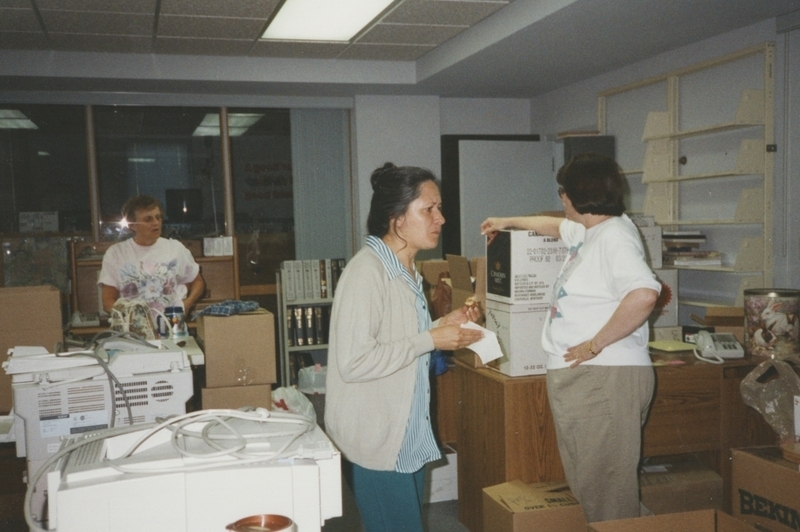 Meridian Library workers take a break from packing up boxes at the old Meridian library building prior to their move into the new Cherry Lane Library building.