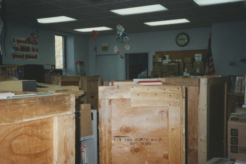 Wooden crates filled with books sitting in the Children's section awaiting the move to the new Cherry Lane Library building. 