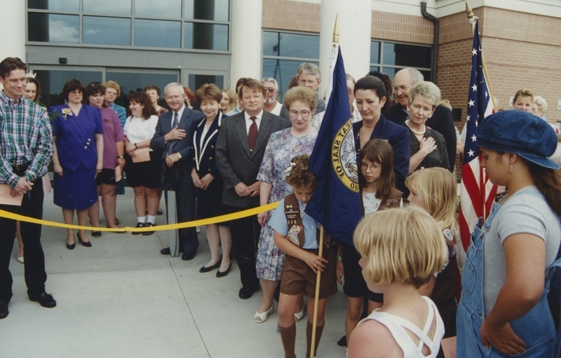 Crowd at the Cherry Lane Open House watch as Brownies plant the flags in the flag ceremony. 