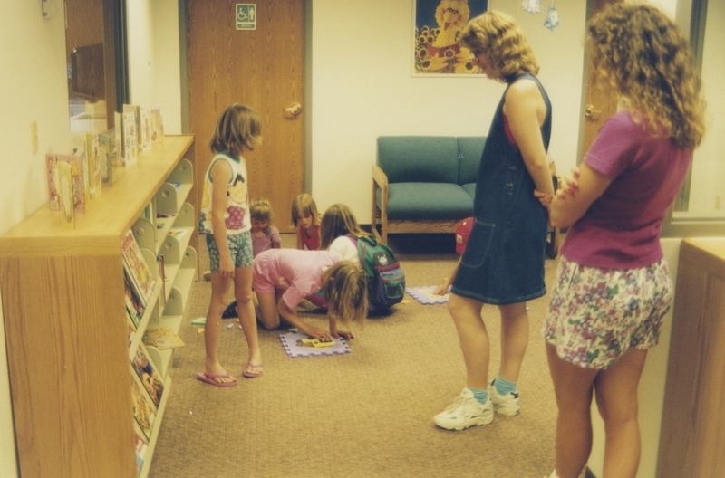 A woman and children interact with the children's section of the new Cherry Lane Library during the open house. 