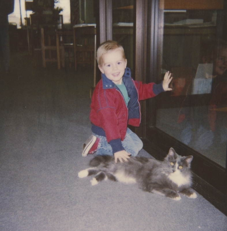 Boy Pets Gray and White Cat at the Meridian Library, circa 1990. 