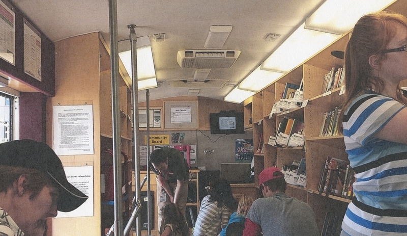 Patrons look for books inside the MLD Bookmobile, circa 2016. 