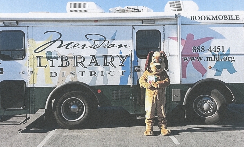 Rascal, Meridian Library District's mascot, stands outside the bookmobile, circa 2016. 