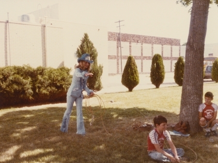 Myla Meiers, Caldwell Night Rodeo champion demonstrates lassoing on a boy from the audience.