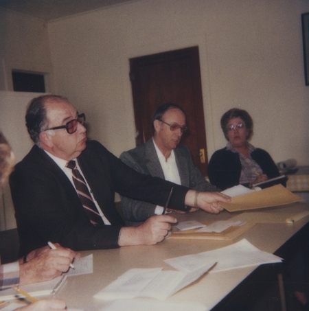 Meridian Library Board Chairman Jack Riddlemoser conducting the opening of bids for a new library expansion project. 