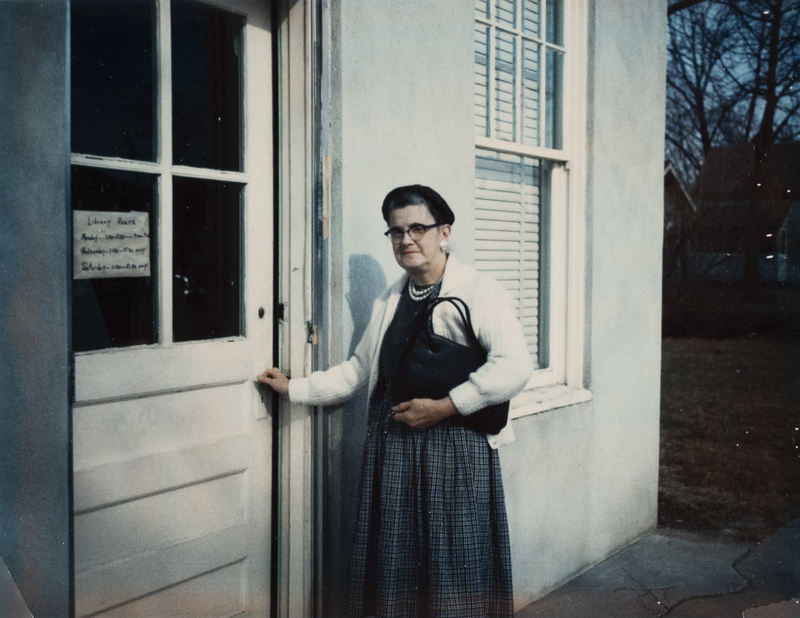 Librarian Nancy Sage in front of the library entry (date unknown-perhaps 1950s)