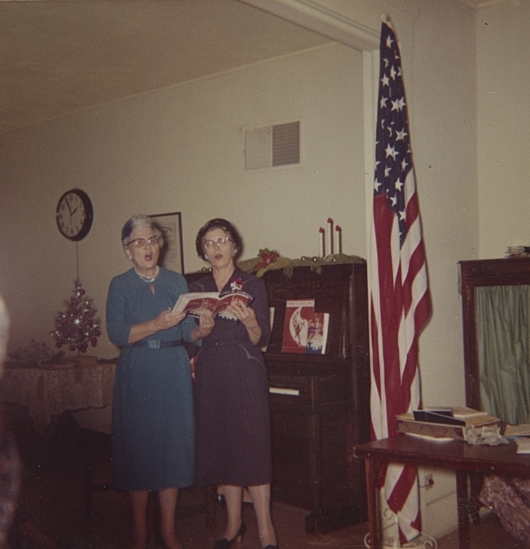 Mrs. John Pratt and Mrs. Francis Veach Sing during December 1962 meeting