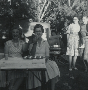Mrs. May Howell and Mrs. Lucille Wood work as chasiers for the ice cream social