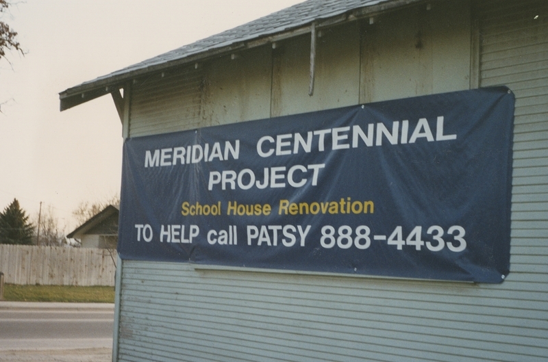 Side of unrenovated Pine Street School House, with sign advertising the renovation project with a help number, circa early 1993