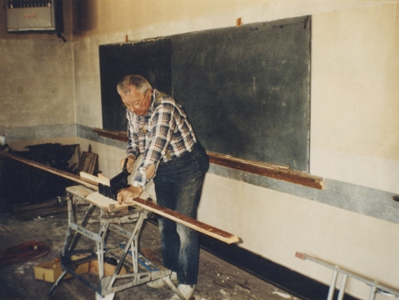 Leonard Rutan installing chalkboards as part of Pine Street School renovation project, 1993