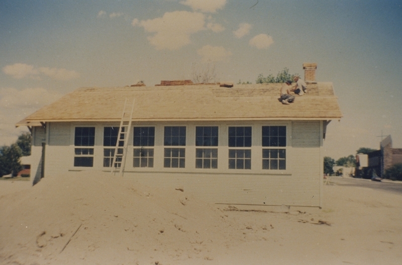 Robin Walker works on reshingling the Pine Street School, 1993