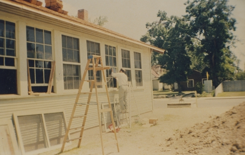 Rev. Kent Roberts works on repairing the windows of Pine Street School, 1993