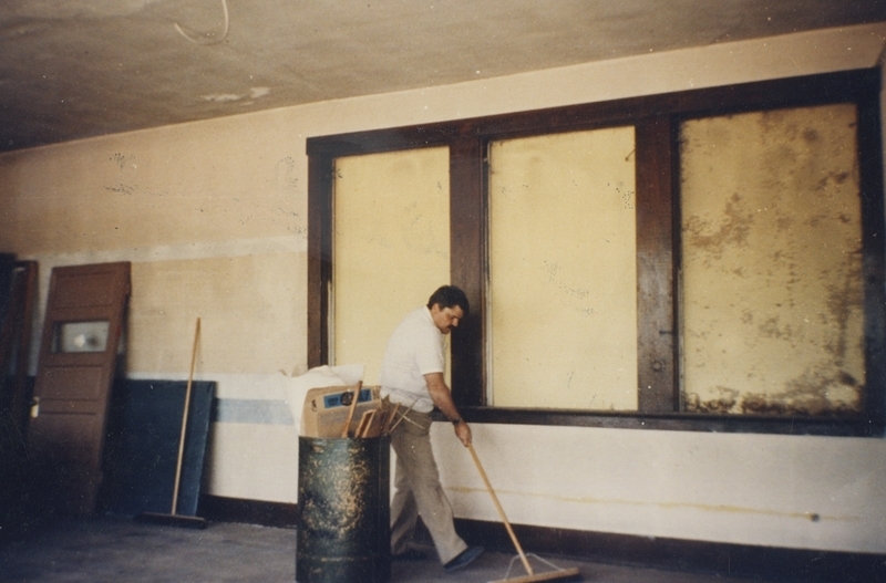 Doug Rutan sweeps inside the Pine Street School during the renovation, 1993